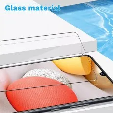 Tempered glass screen protector being applied to an Oppo Find X2 Lite, highlighting its clear glass material and precise fit