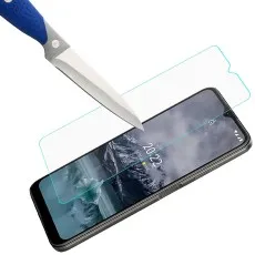 empered glass screen protector resists scratches, demonstrated with a knife above a smartphone display.