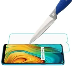 Realme 3i Tempered Glass Screen Protector being tested for scratch resistance with a knife, demonstrating durability