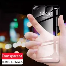 Hand holding a highly transparent tempered glass screen protector, showcasing its clarity and smooth finish