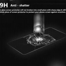 9H anti-shatter screen protector resisting a steel ball impact, showing cracks but remaining in one piece..