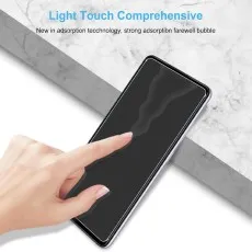 Hand touching a Samsung Galaxy A73 5G phone with a screen protector.