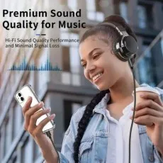 Person outdoors using over-ear headphones connected to an iPhone with the black aux cable, illustrating high-fidelity sound quality for music listening