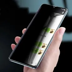 Hand holding a phone with a privacy screen, making the content visible only directly in front..