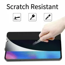 Hand scratching a privacy screen protector on a phone with a key, showing scratch resistance
