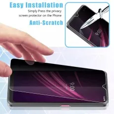 Hand applying anti-scratch privacy screen to a OnePlus phone