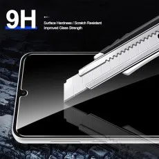 A razor blade tests the 9H scratch resistance of a phone screen protector