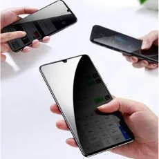 Hands holding three phones with privacy screens, showing only a small portion of the displays