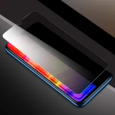 A Privacy Screen Protector, a transparent film, being placed onto a smartphone with a colorful display