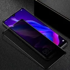 A smartphone next to a privacy screen protector on a dark, textured surface