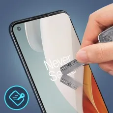 A hand applies a clear screen protector to a smartphone with the text Never Se