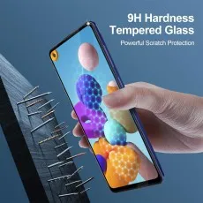 A hand holds a phone with a screen protector, surrounded by drill bits, showcasing its hardness