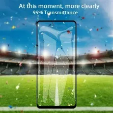 A smartphone screen protector over a stadium background with confetti, showcasing 99% transmittance