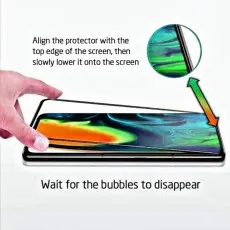 A hand applying a screen protector to a phone, with text instructions on alignment and bubble removal