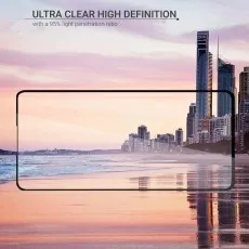 A smartphone screen protector showing an ultra-clear, high-definition view of a beach and city