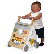 A smiling baby using a Janod wooden multi-activity baby walker