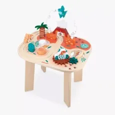 A front view of the assembled Janod wooden activity table, showing its dinosaur theme with a bead maze, a volcano ramp, and spinning gears..