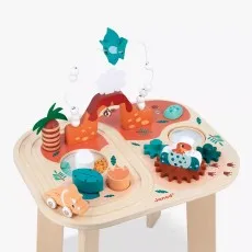 The fully assembled Janod wooden activity table is shown on a white background, highlighting its various activities like the bead maze with a pterodactyl and wooden vehicles