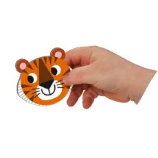 child’s hand holds a smiling tiger puzzle piece.