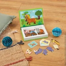 Janod animal puzzle box open on the floor with pieces scattered next to a blue honeycomb ball.