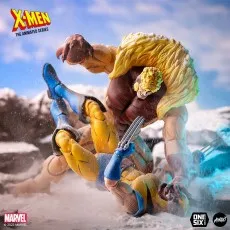 Mondo X-Men Sabretooth figure overpowering a Wolverine figure on the snowy ground.