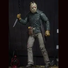 Jason Voorhees action figure wearing a hockey mask and holding a knife in a barn setting.