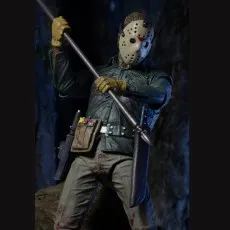 Jason Voorhees action figure with a hockey mask, spear, and a knife in a dark cave setting.