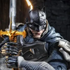 Close-up of a medieval Batman figure holding a golden sword.