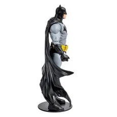 A collectible toy of Batman in his iconic gray and black comic book suit, viewed from the side..