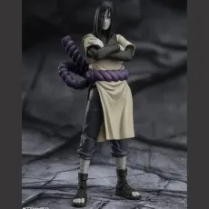A collectible Orochimaru figure with his arms crossed, against a gray, rocky background.