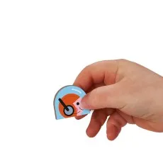 A small hand holding a magnetic toy piece featuring a smiling pilot wearing a headset