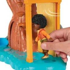 A close-up of a hand opening a golden door on the Encanto playset, with the Antonio figure.