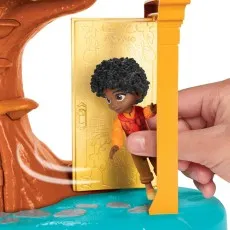 The Antonio figure from Encanto stands on a step, activating a door that opens within the playset.