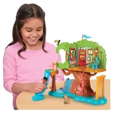 A young girl smiling as she plays with the Disney Encanto Antonio's Magical Treehouse playset..
