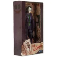 A boxed action figure of the Joker from The Dark Knight, with a weapon in the background and Joker-themed art on the packaging