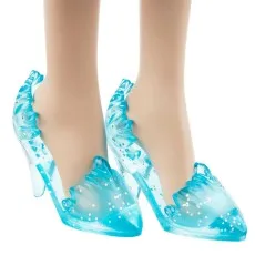 A close-up of a doll's feet wearing translucent blue high heels with silver glitter and a wavy design.