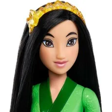 A close-up of a Mulan doll's head and shoulders, showing her black hair, tiara, and green top