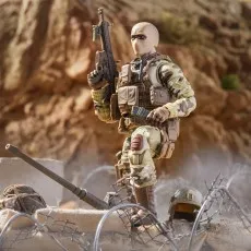 A G.I. Joe Action Soldier figure wearing a balaclava and carrying a machine gun and pistol.