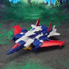The Metalhawk figure in its jet form, a futuristic aircraft with blue, white, and red parts, is on a glittery ground.