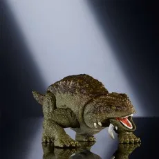 A Jurassic World Hammond Collection Scutosaurus figure standing on a reflective surface.