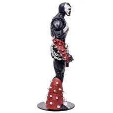 A Spawn action figure in a black and white costume with a red, spiked arm guard and leg armor, standing on a black circular base