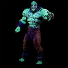 A menacing Killer Croc action figure with its arm outstretched, glowing in the dark against a black background