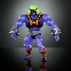 An action figure with a muscular purple body, black and orange harness, and spiked wristbands, against a dark gray background.