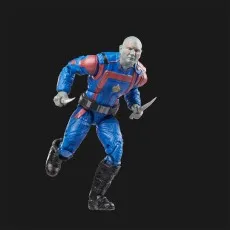 A running Drax action figure holding a knife in each hand on a black background