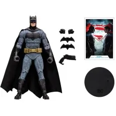 A Batman action figure from Batman v Superman with its accessories laid out next to it, including a display stand.