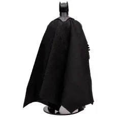 A collectible Batman toy with a long, black fabric cape, viewed from the rear.