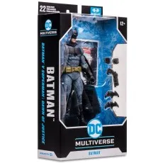 A packaged Batman action figure from the Batman v Superman movie, with accessories visible next to it.