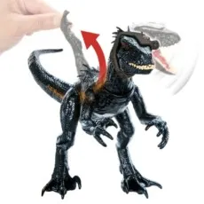 A toy Indoraptor on a white background. An action feature is being demonstrated by a hand moving its arm up.