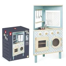 A Janod brand wooden toy kitchen stands next to its dark blue cardboard box packaging.
