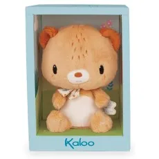 A soft brown teddy bear with a white belly, wearing a patterned ribbon, sits in a light blue box